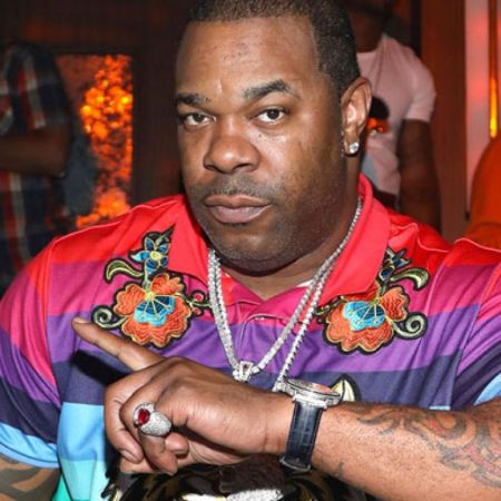 Busta Rhymes in a colorful picture poses a picture.